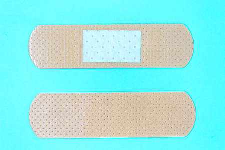 skin color medicine adhesive healing bandage layout on blue background. medical aid patch conceptの写真素材