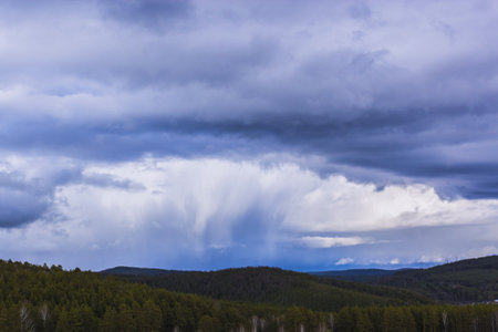 Dramatic thunderstorm clouds background at blue skyの写真素材