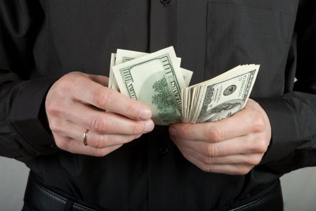 man counts money in hands dollar usa