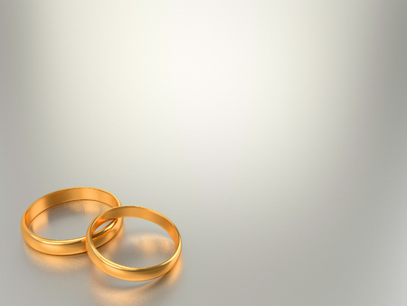 Two wedding gold rings lie on each other with blank space for textの写真素材