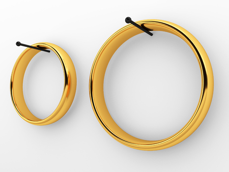 Two wedding rings hanging on nails. Relationships in the family conceptの写真素材