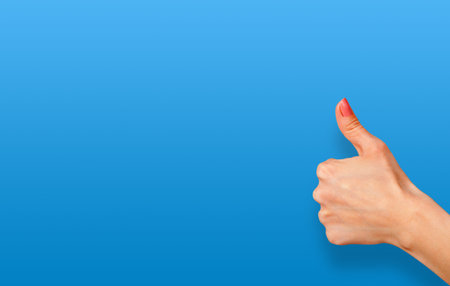 Blue background and hand with a raised thumb up