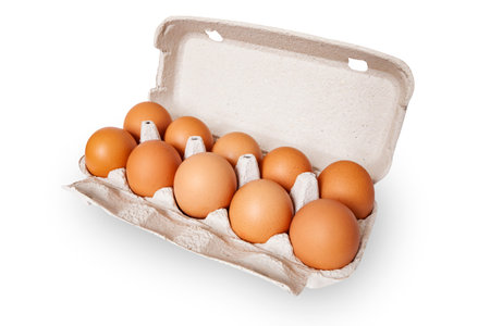 Chicken eggs in open cardboard box isolated on white background. He healthy eating.