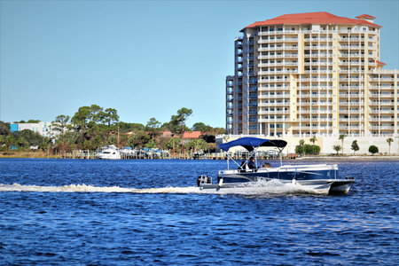 USA, Florida, Photo taken from Santa Rose Island - October 2020. Speedboat sails on the water of Santa Rosa Sound. The mainland coast is visible in the backgroundのeditorial素材