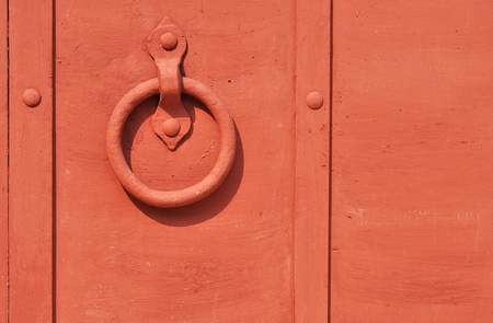 Red painted old iron door with circle doorhandleの写真素材