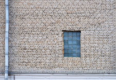 Old gray bricks weathered wall vintage backgroundの写真素材