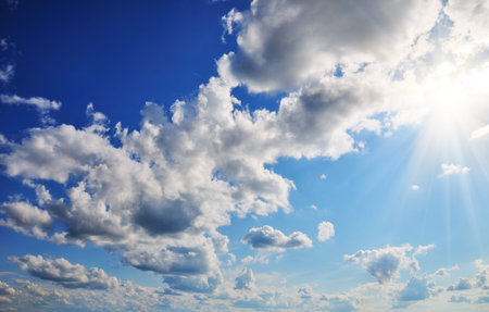 Wonderful clouds and sun against blue sky
