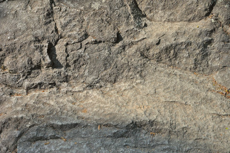 Weathered aged cracked rough stone surface background