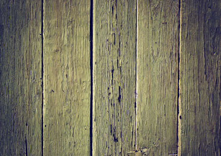 Obsolete weathered yellow painted wooden planks backgroundの写真素材