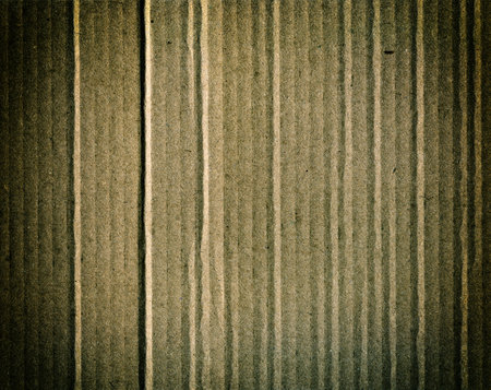 Textured recycled cardboard with natural fiber parts grunge backgroundの写真素材