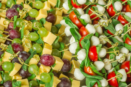 appetizer with white and red grapes on bamboo skewersの写真素材