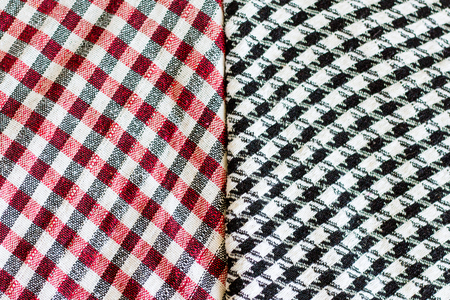 Two wool scarfs. The keffiyeh is a black, red or blue and white scarf that is usually worn around neck or headの写真素材