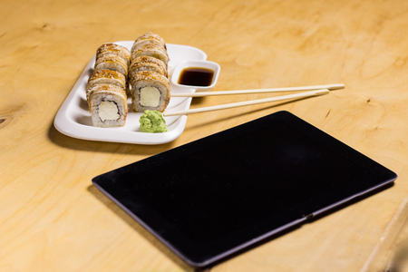 Sushi roll with cream cheese, sesame on the tableの写真素材