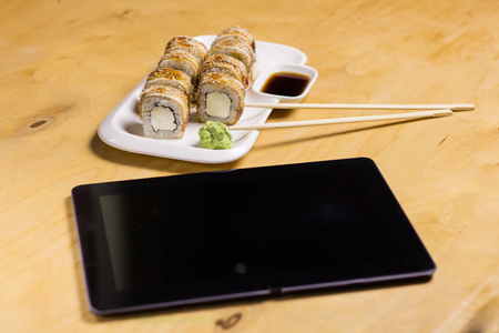 Sushi roll with cream cheese, sesame on the tableの写真素材