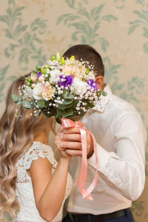 Bride and groom are holding bridal bouquetの写真素材