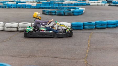active man competing on racing cars at kart circuitの写真素材