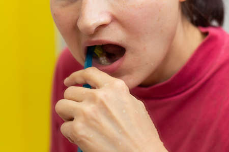 Girl with dental braces and brackets holding toothbrush for dental hygieneの写真素材