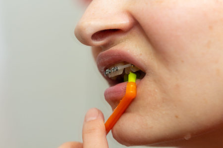 Girl with dental braces and brackets holding toothbrush for dental hygieneの写真素材