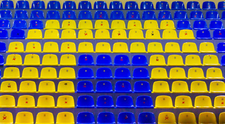 Yellow and blue stadium empty chairs stands quarantineの写真素材