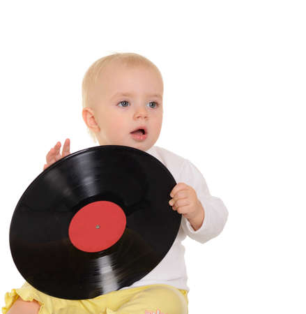 cute baby playing with old vinyl record on white backgroundの写真素材