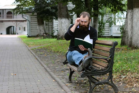 man reading books in the parkの写真素材