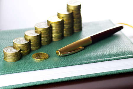 coin exchange rate glasses pen notebookの写真素材