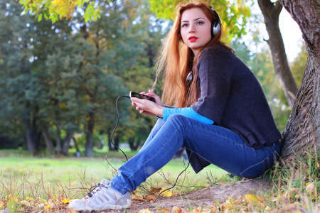 Girl autumn leaves casual playerの写真素材