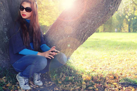 Girl autumn leaves casual playerの写真素材