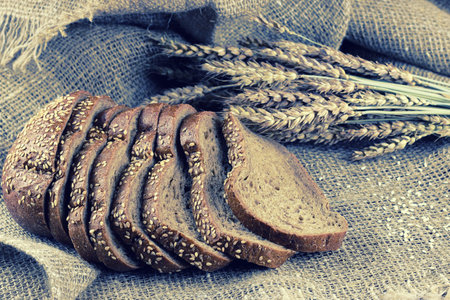 rye bread and ears on the tableの写真素材