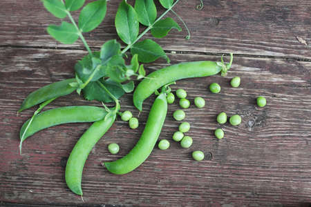 pea pod on the wooden brown backgroundの写真素材