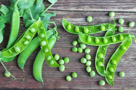 pea pod on the wooden brown backgroundの写真素材