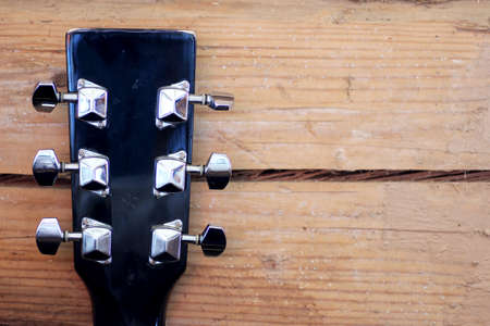 black guitar neck on grey wooden backgroundの写真素材