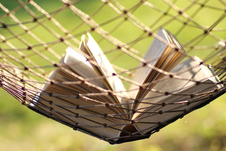 book in a hammock nobody blur background summer landscapeの写真素材