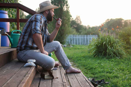 man smoking  pipe at outdoor  village outdoorの写真素材