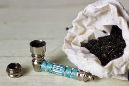 small marijuana pipe on white wooden backgroundの写真素材