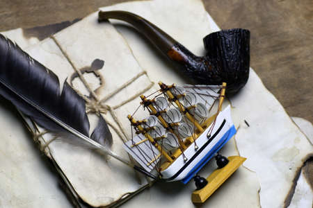 old paper   and black feather on wooden tableの写真素材