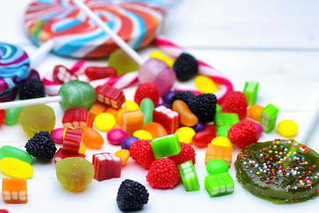 sweet candy jelly bean on a white wooden backgroundの写真素材