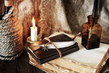 pirate objects book and candle on wooden tableの写真素材