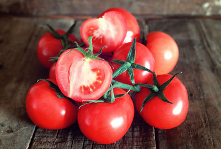 fresh red tomatoes on old wooden backgroundの写真素材