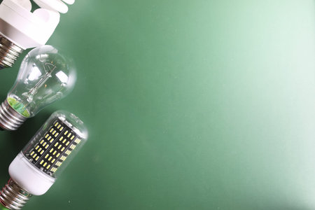 different light bulbs on green background
