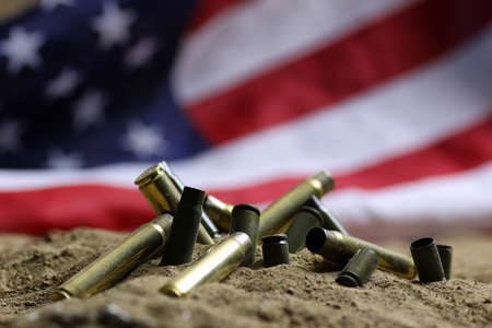 bullet and usa flag in the sandの写真素材