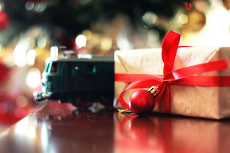 gift with christmas ball and train on tableの写真素材