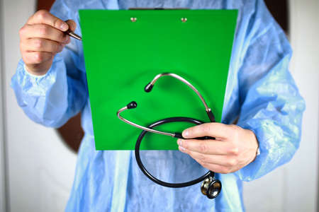 A doctor writing on clipboardの写真素材