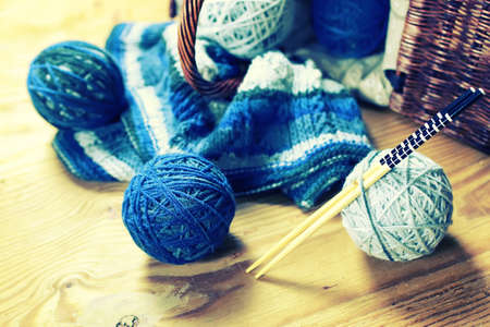 wool balls and knitting needles on a wooden backgroundの写真素材