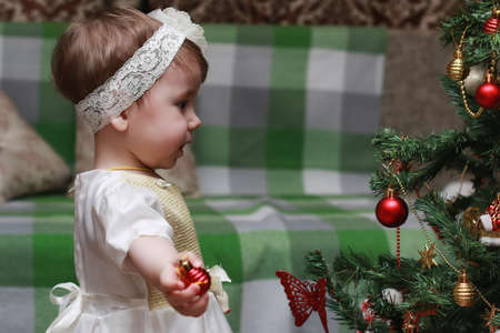 little girl decorating the Christmas treeの写真素材