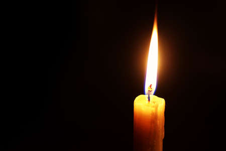 candle flame isolated on black religion conceptの写真素材