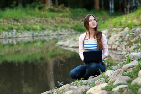 pretty female student outdoor in autumn seasonの写真素材