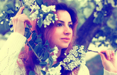 red hair woman in flower parkの写真素材