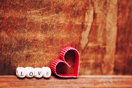 shape with letter love on wooden background