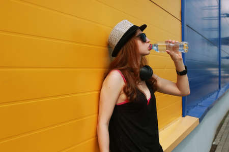 hipster girl at the wall posing on cameraの写真素材